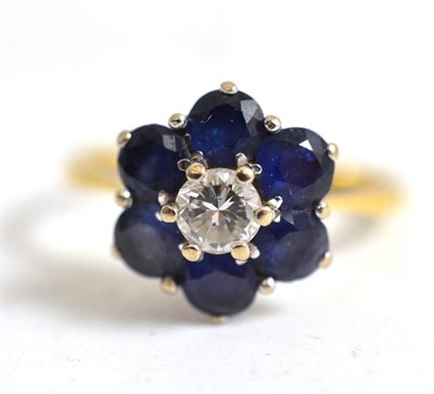 Lot 101 - An 18ct gold diamond and sapphire cluster ring, diamond weight 0.35 carat approximately