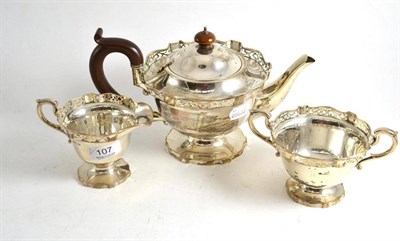 Lot 107 - Silver three piece tea service with pierced rims, Birmingham 1926