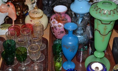 Lot 142 - Two trays of assorted coloured glassware, two glass lustres and drops, vases, Mary Gregory...