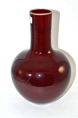 Lot 147 - A burgundy glazed onion shaped bottle vase