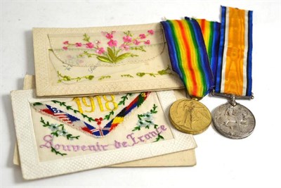 Lot 186 - A British Empire war medal and a victory medal (also British Empire) and four silk embroidered...