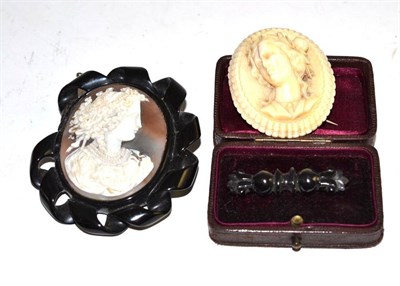 Lot 193 - A cameo and jet brooch (a.f.), a jet brooch and another cameo brooch