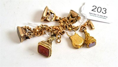 Lot 203 - A charm bracelet hung with four seal fobs and other charms