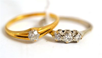 Lot 209 - A diamond solitaire ring and a diamond three stone ring