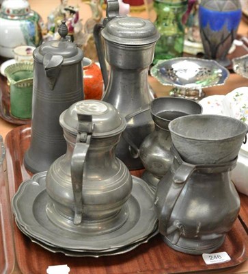 Lot 246 - Three pewter plates, two lidded flagons, lidded jug, two tankards and a funnel