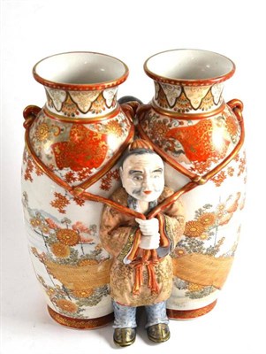 Lot 333 - A Japanese kutani porcelain vase modelled as two vases with a figure of a man standing either side