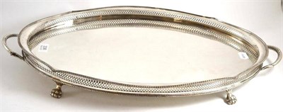 Lot 336 - A silver plated two handled tray with pierced border and twin handles