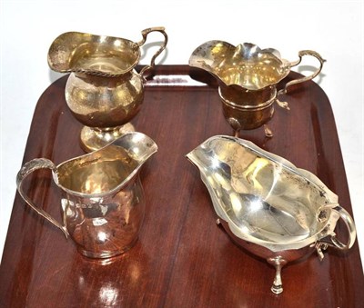 Lot 371 - A silver sauce boat and three silver cream helmets