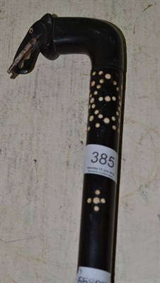 Lot 385 - A 19th century ebony inlaid walking stick with a carved elephants head handle