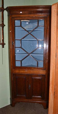 Lot 455 - Late George III oak and mahogany crossboanded corner cabinet