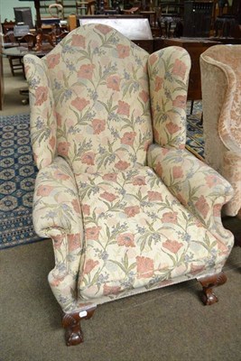 Lot 511 - Late 19th/early 20th century wing back chair recovered in beige and floral fabric