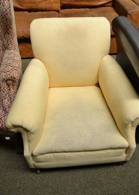 Lot 524 - A yellow upholstered armchair