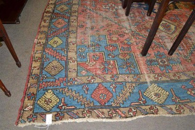 Lot 528 - A large Eastern pattern carpet with red ground and geometric motifs