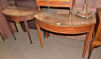 Lot 564 - A Georgian mahogany demi lune fold over card table and bow front side table