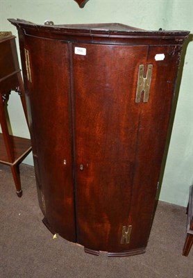 Lot 566 - A George III mahogany corner cupboard