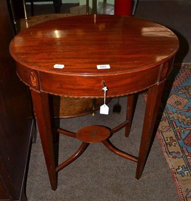 Lot 582 - An Edwardian mahogany inlaid oval occasional table with hinged top