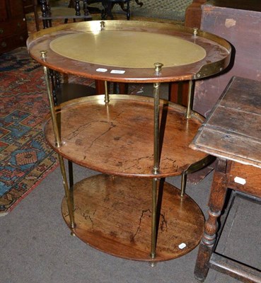 Lot 585 - A 19th century mahogany three tier side table with brass mounts and later top