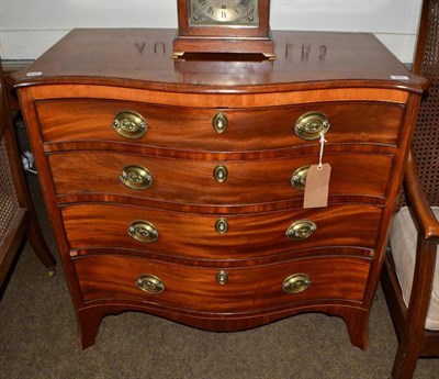 Lot 594 - A 19th century mahogany serpentine fronted chest of four drawers