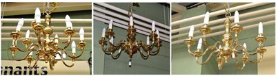 Lot 596 - A brass fourteen branch chandelier and a pair of brass eight branch chandeliers