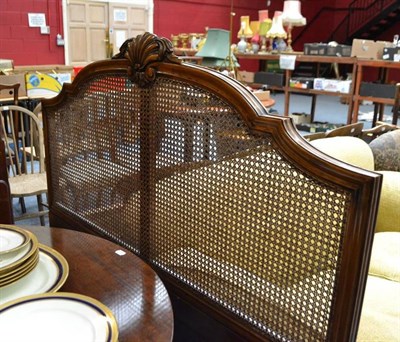 Lot 613 - An early 20th century bed with caned bed head and end