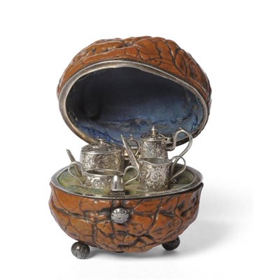 Lot 619 - A Miniature Four Piece Tea and Coffee Service in a Walnut Shell Case, 19th century, the white metal