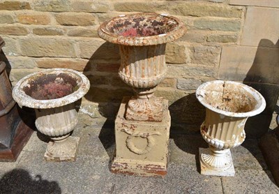 Lot 678 - A cream painted cast iron garden pedestal on stand and two others