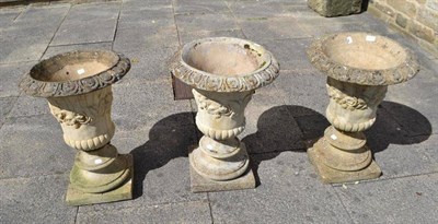 Lot 683 - Three similar stone pedestal garden urns on square bases