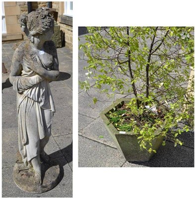 Lot 685 - A reconstituted hexagonal stone planter with shrub and a figure of a maiden