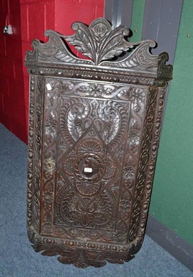 Lot 693 - A 19th century heavily carved oak wall cabinet