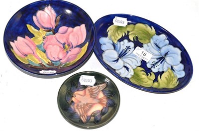 Lot 18 - Moorcroft magnolia circular dish, a Walter Moorcroft hibiscus oval dish and a 1993 Moorcroft...
