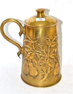 Lot 50 - An Arts & Crafts brass jug and cover, embossed with fruiting pears, unmarked, 34.5cm