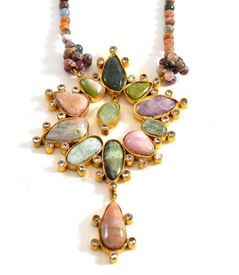Lot 78 - A tourmaline necklace, polished tourmaline beads meet at a large centrepiece, inset with...