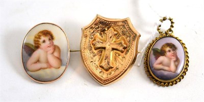 Lot 82 - A cross motif brooch and two Cupid decorated pieces