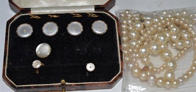 Lot 84 - A cased part dress stud set, with mother-of-pearl and seed pearl centres, and two strands of...