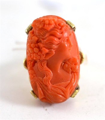 Lot 87 - A coral type ring, depicting a bacchante, on a lined shank, finger size U
