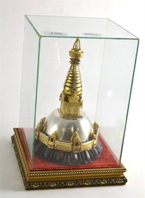 Lot 145 - Eastern white and gilt metal model of a shrine in a fitted glazed case