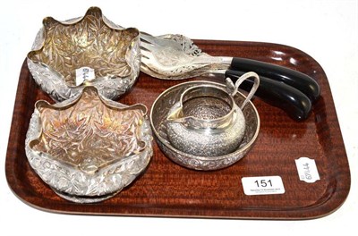 Lot 151 - Pair of embossed Indian white metal dishes, similar jug and bowl and a pair of servers (6)