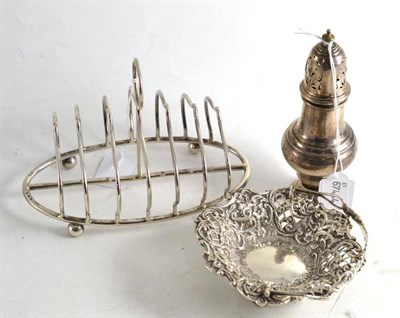Lot 185 - Silver sugar caster, embossed silver bonbon dish with handle, seven bar silver toast rack (3)