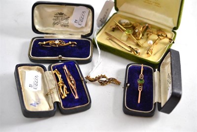 Lot 220 - Twelve bar brooches, including a diamond set cased example, a peridot bar brooch, seed pearl...