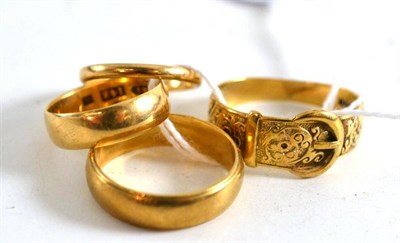 Lot 233 - A buckle ring, two 9ct gold rings and a ring stamped '14k' (3)