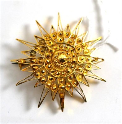 Lot 235 - A filigree starburst brooch/pendant