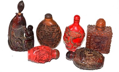 Lot 239 - A Chinese carved and stained horn snuff bottle; anther decorated with carp amongst lotus; and...