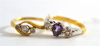 Lot 249 - An amethyst and diamond three stone ring, stamped '18ct' and a diamond twist ring (2)