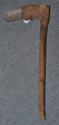 Lot 261 - A 19th century Polynesian adze, the grey hardstone blade secured to the wood haft with twisted...