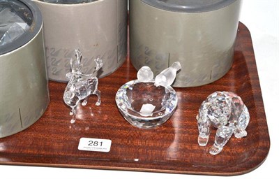 Lot 281 - Three Swarovski crystal figures including a seated bear, two birds drinking from a bird bath...