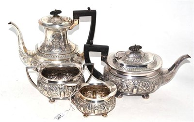 Lot 286 - An Edward VII silver four piece tea service, Sheffield 1901, profusely chased with flowers and...