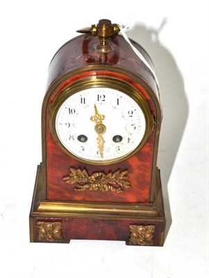 Lot 316 - A tortoiseshell striking mantel clock, circa 1900, arched case with loop carrying handle,...