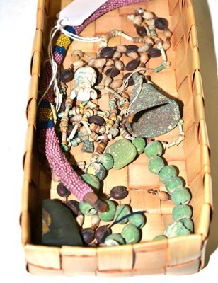 Lot 339 - A small quantity of Egyptian mummy beads including a figural pendant, a jade pendant and a bell