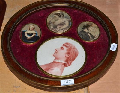 Lot 377 - Brass mounted circular framed display of four portrait miniature, three printed and hand coloured