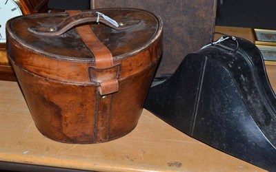 Lot 382 - Henry Heath black silk top hat in tan leather case and a black painted tricorn hat tin (2)